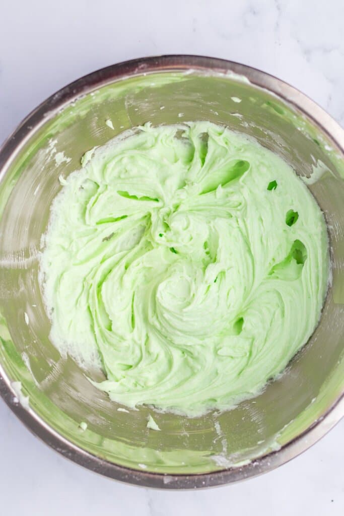Frosting in a stainless steel bowl.