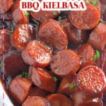 White bowl full of baked bbq kielbasa.