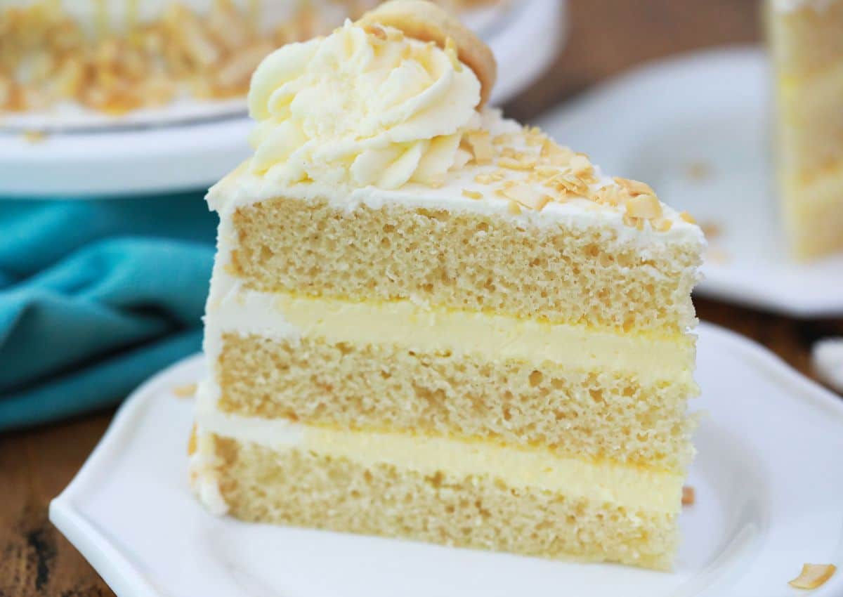 Slice of banana pudding layer cake on a small plate.