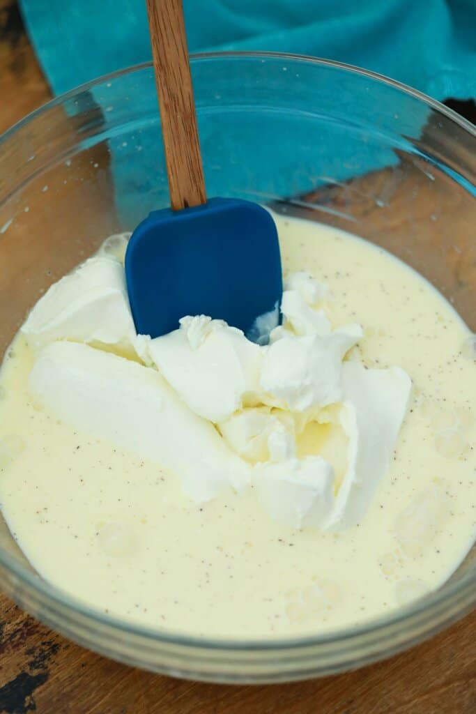 Pudding layer being mixed in a glass bowl.