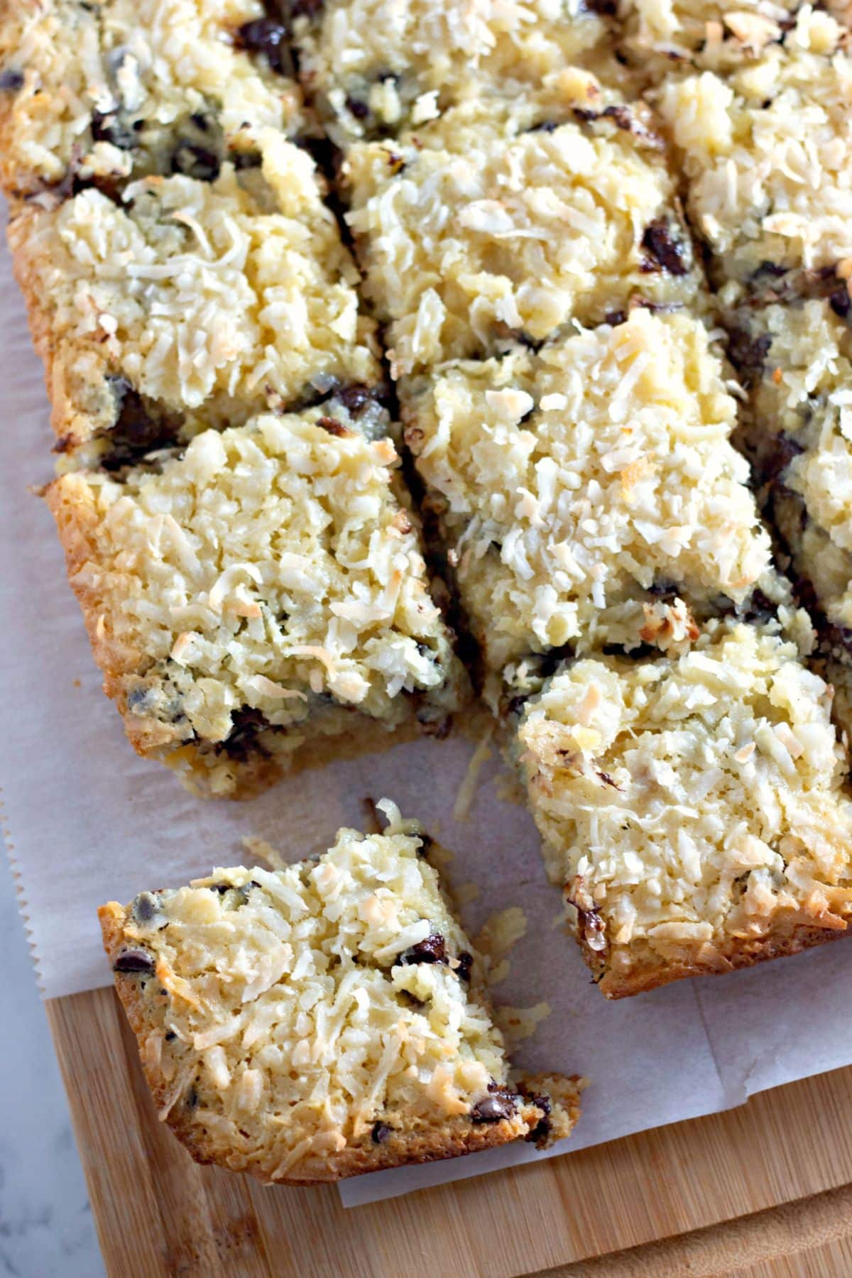 Coconut butter bars being cut on a counter.