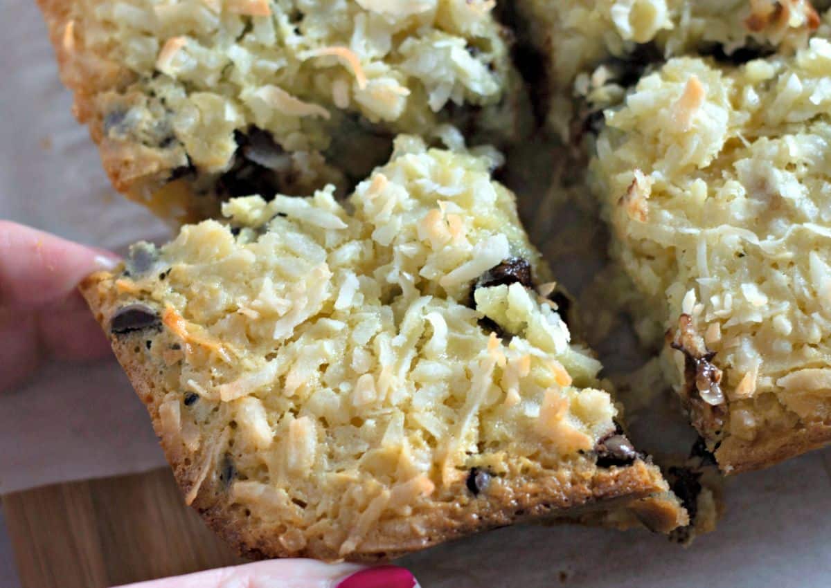 Coconut butter bar being grabbed by a woman's hand.