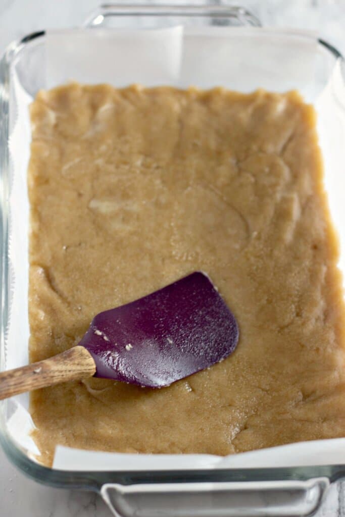 Crust being pressed into a baking dish.
