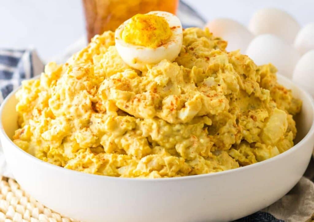 Bowl full of deviled egg potato salad. 