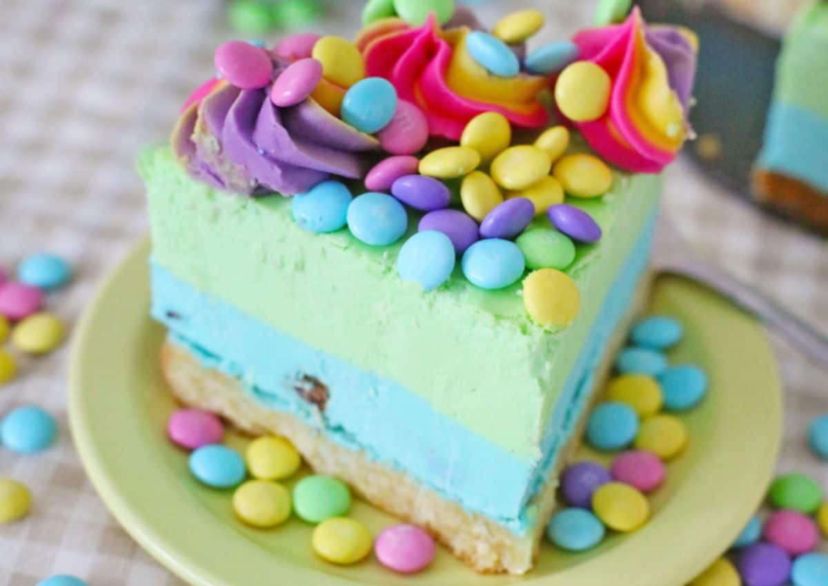 Slice of Easter mm cheesecake on a small plate.