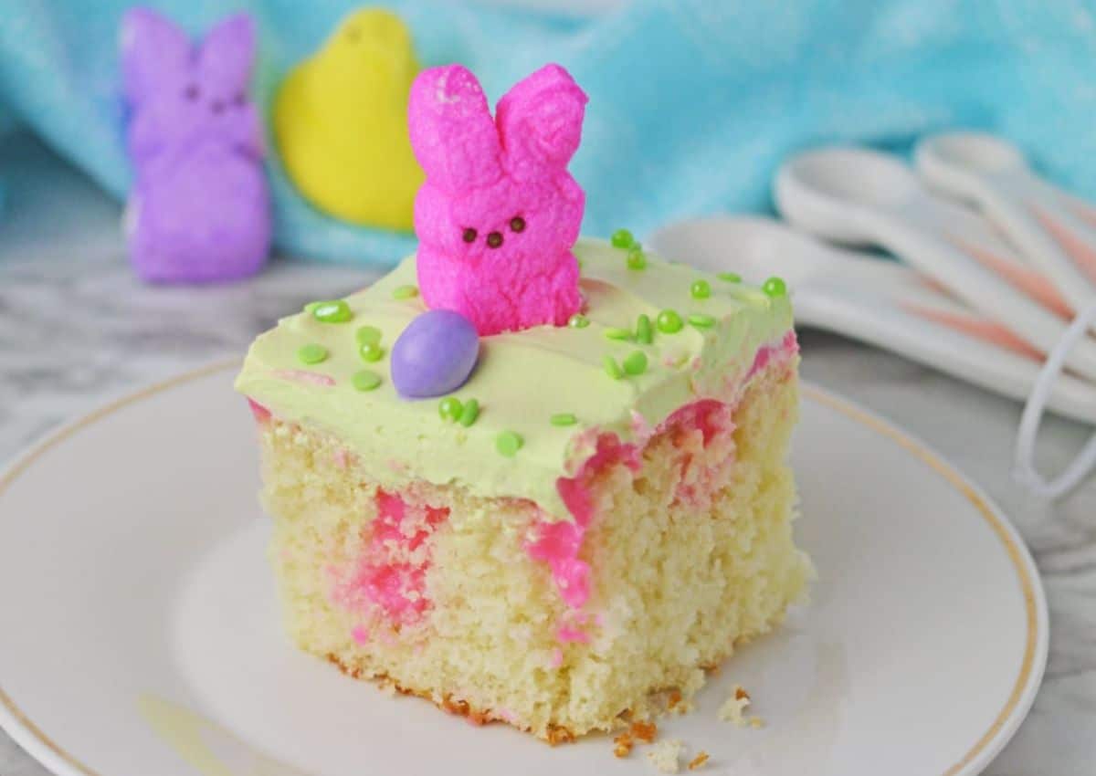 Slice of easter poke cake on a small plate.