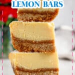 Three lemon bars stacked on top of each other on a counter.