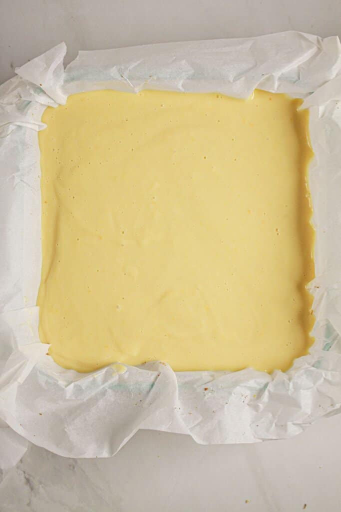 Pie filling in a parchment lined baking dish.