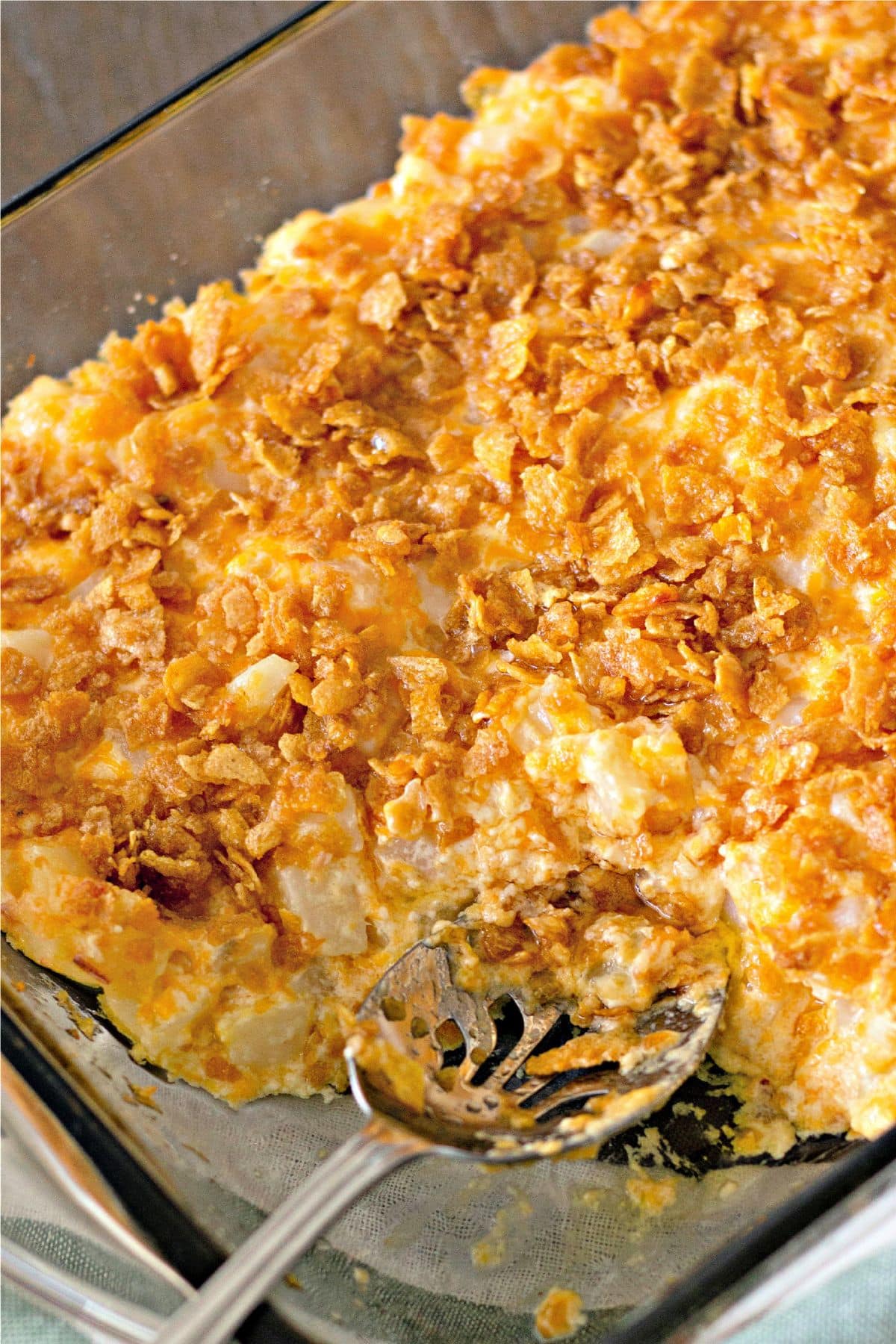 Funeral potatoes in a glass baking dish.