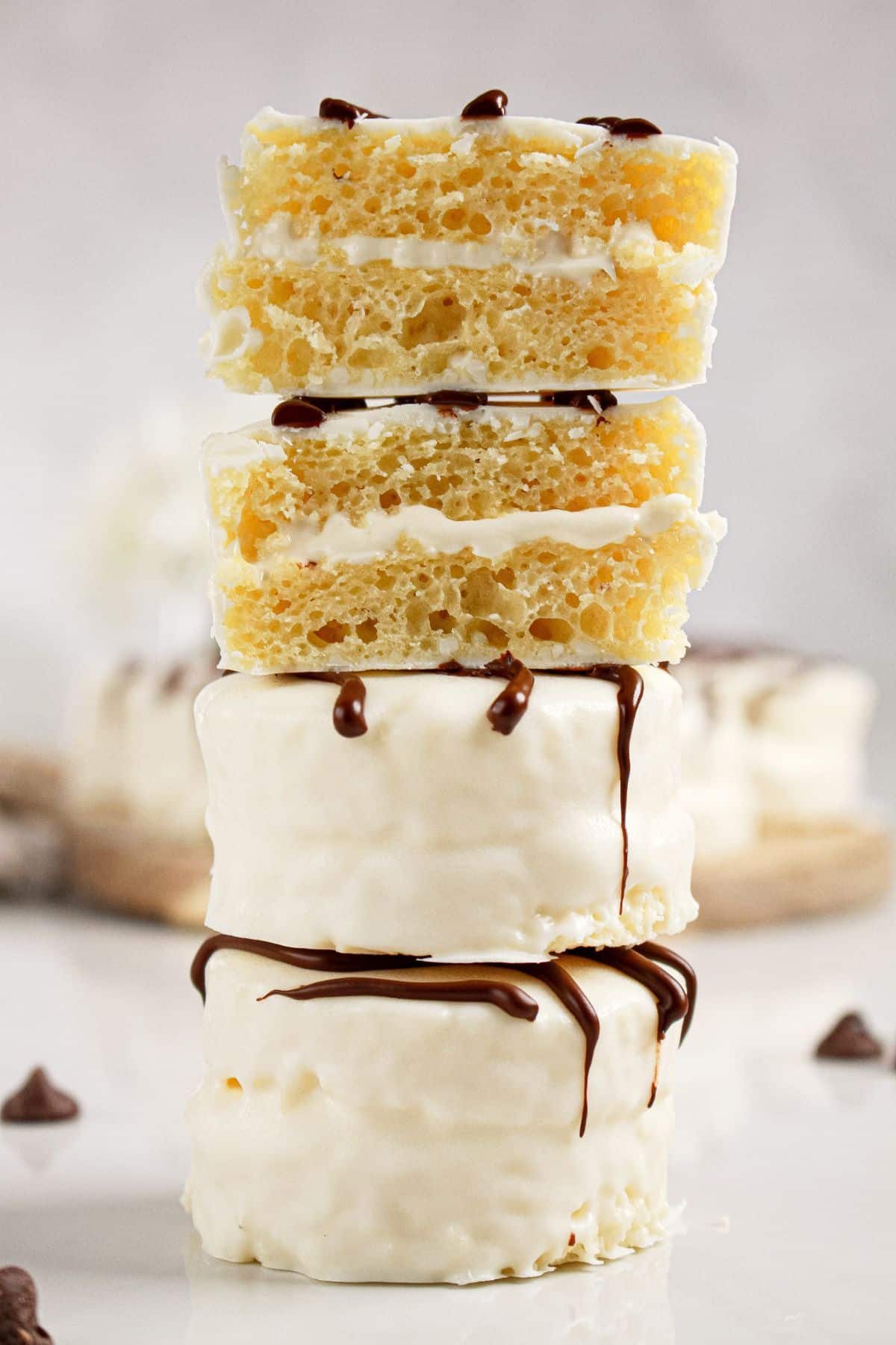 Three homemade zebra cakes staked on top of each other with one broken in half.