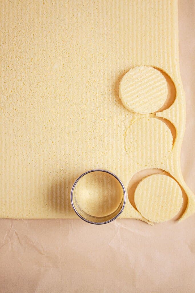 A cookie cutter cutting out circles.