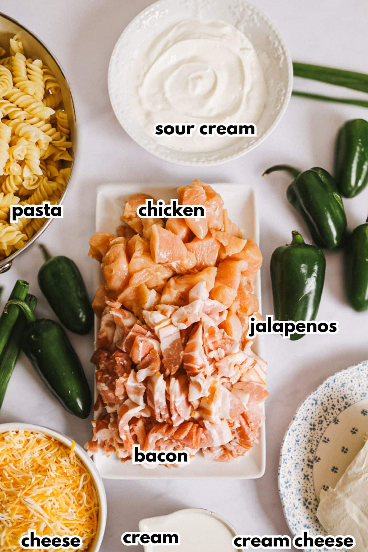 Ingredients for chicken pasta on a counter.