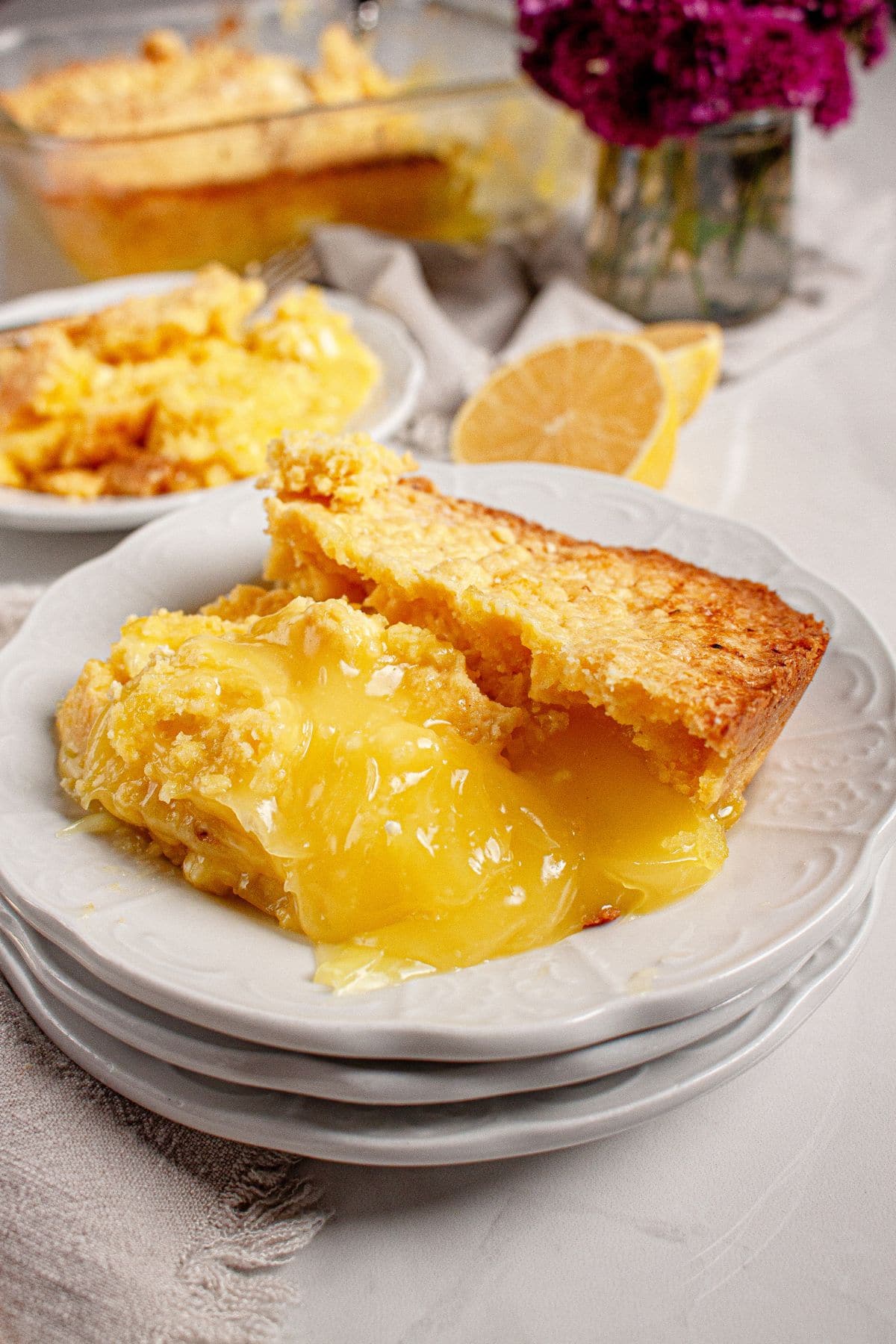 Serving on lemon cream cheese dump cake on a plate.