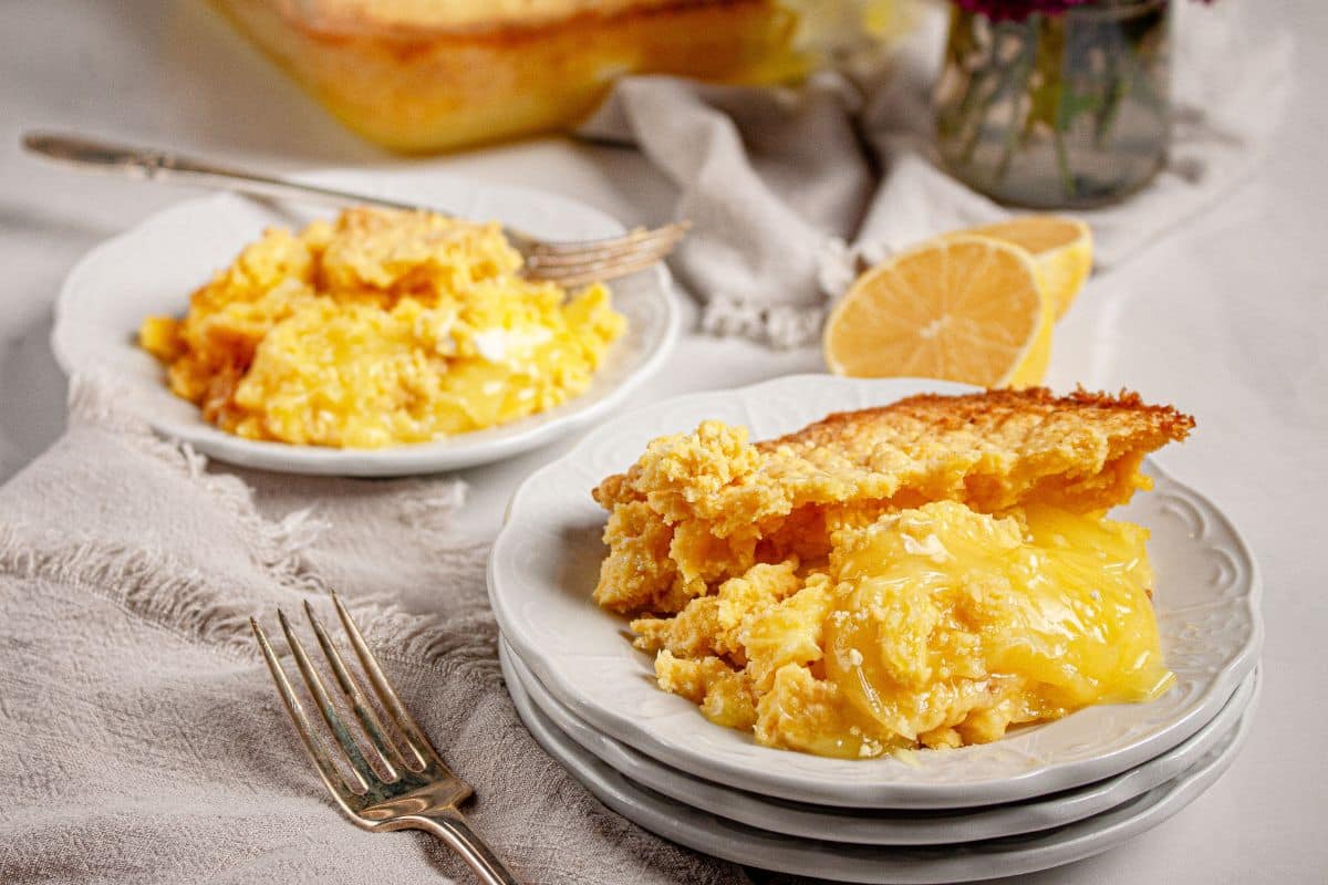 Serving on lemon cream cheese dump cake on a plate.
