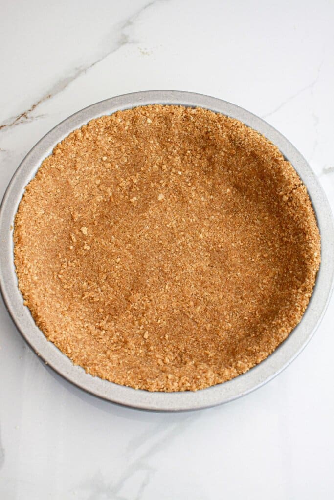 Graham cracker crust pressed into a baking dish.