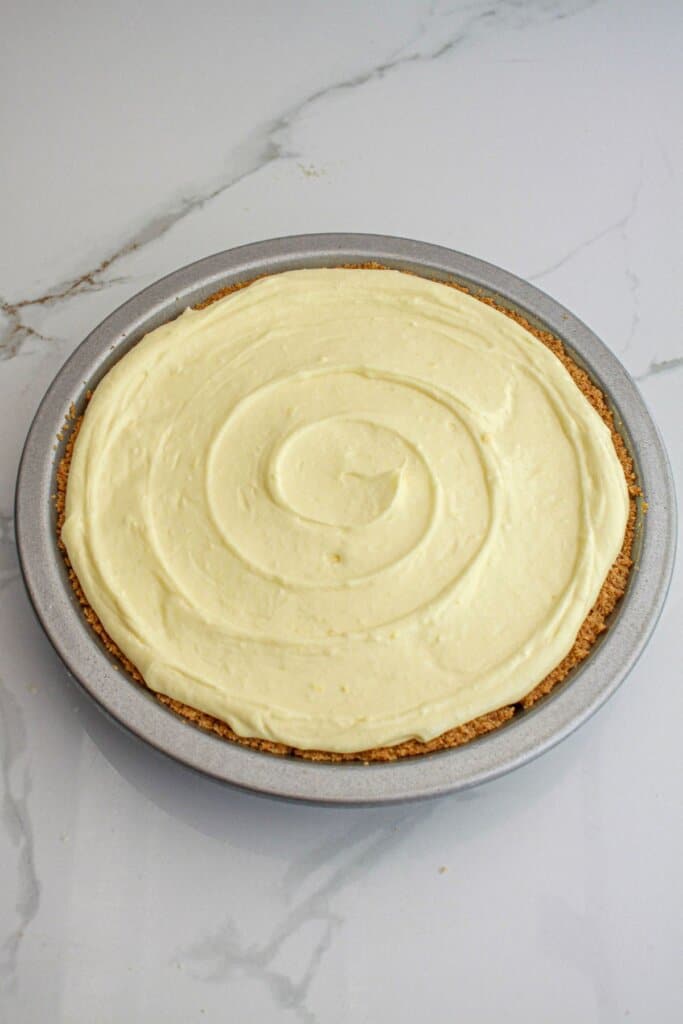 Lemon filling being spread on top of pie.