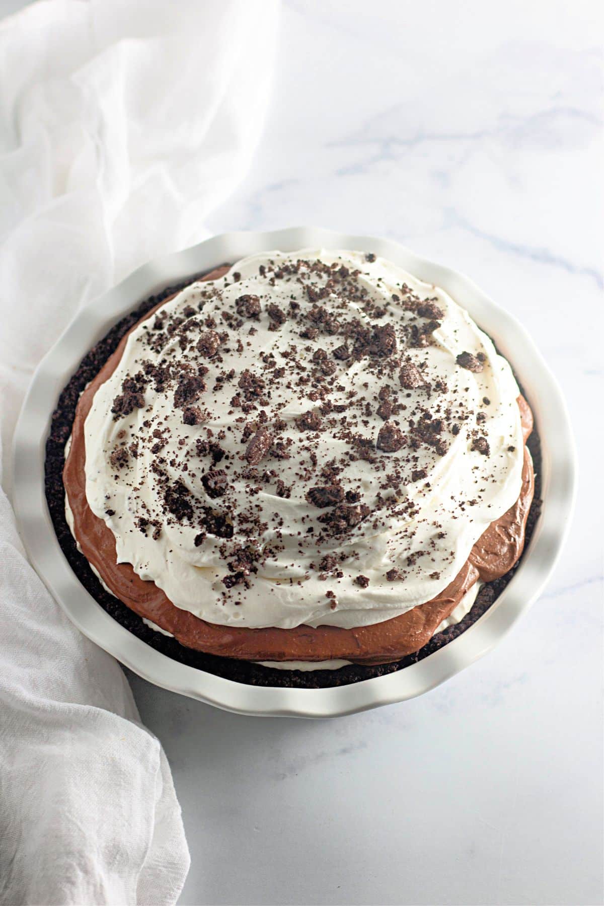 No bake oreo pie in a pie plate on a counter.