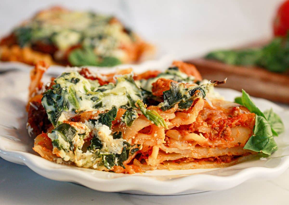 Slice of lasagna on a plate ready to serve.