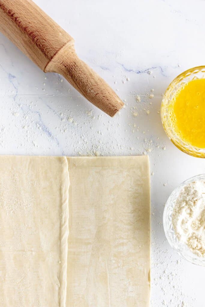 Puff pastry rolled out on a counter.