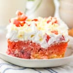 Slice of strawberry earthquake cake on a plate.