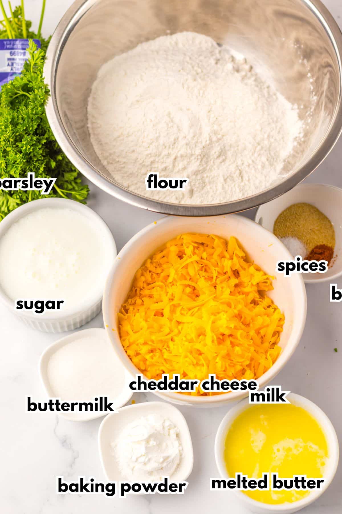 Bowls of ingredients labelled with text on a counter.