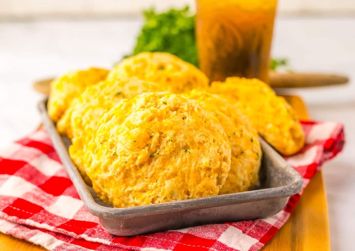 Cheddar bay biscuits in a metal serving tray.