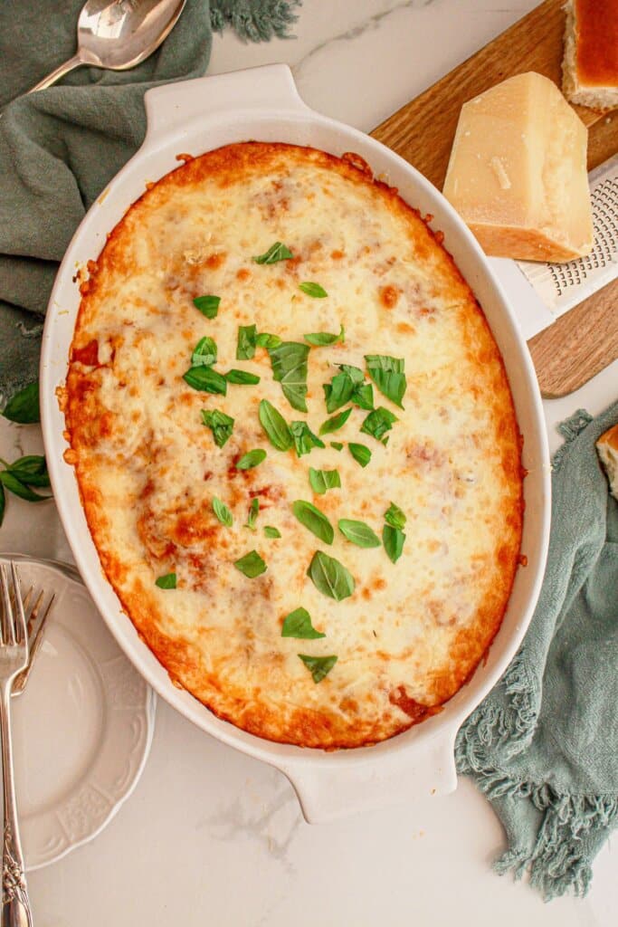 Eggplant parmesan in an oval baking dish on a counter.
