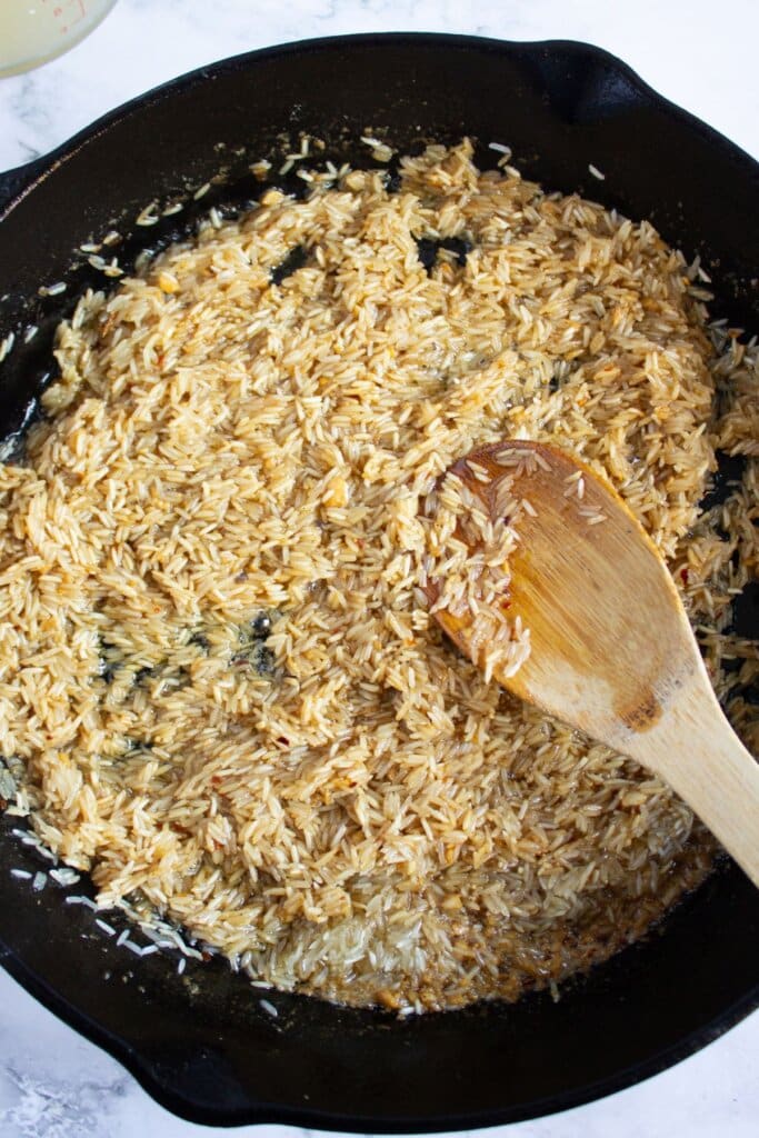 Rice cooking in a cast iron skillet.