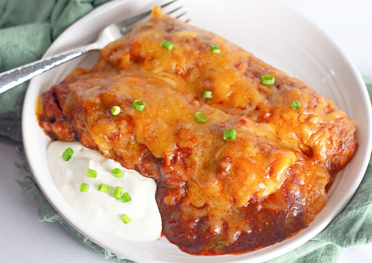 Ground beef enchiladas on a small plate.