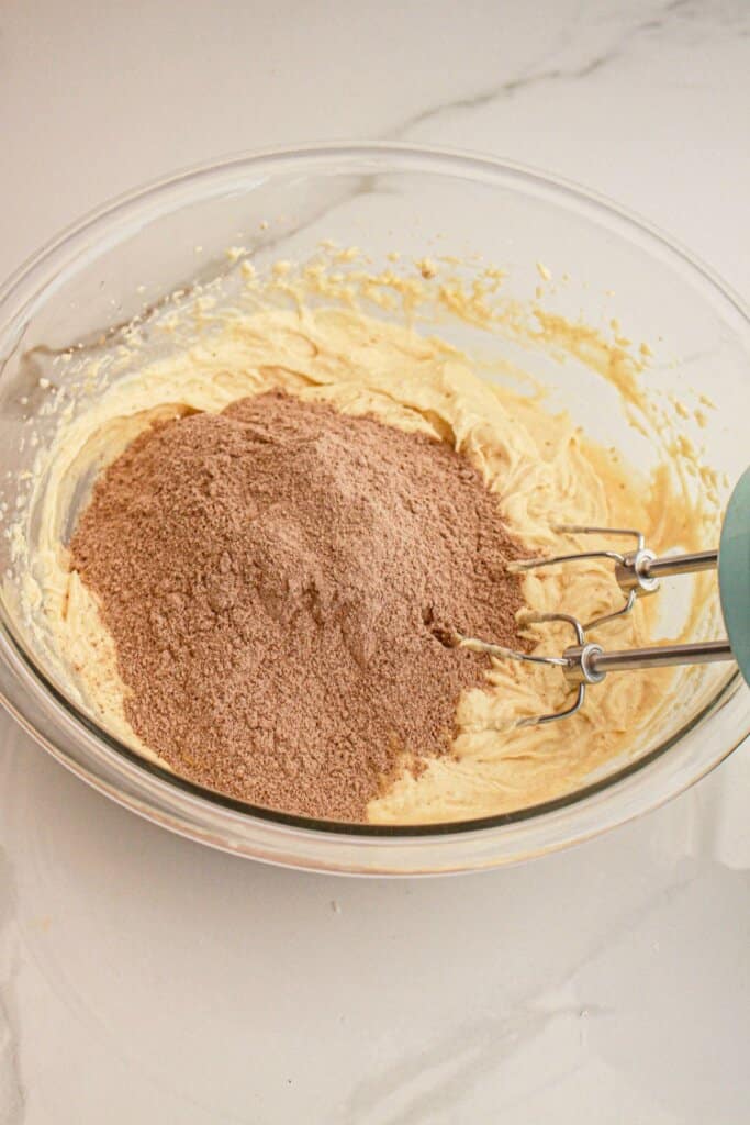 Pudding mix being added to batter.
