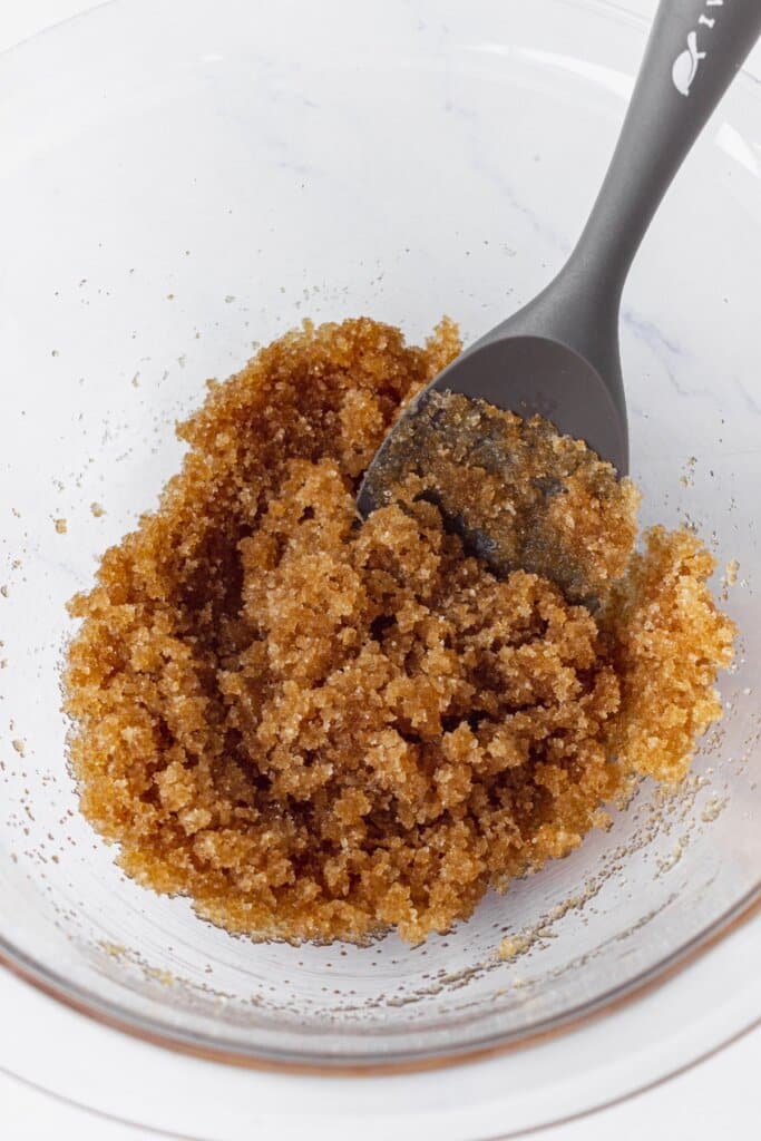 Brown sugar and melted butter in a large glass bowl.