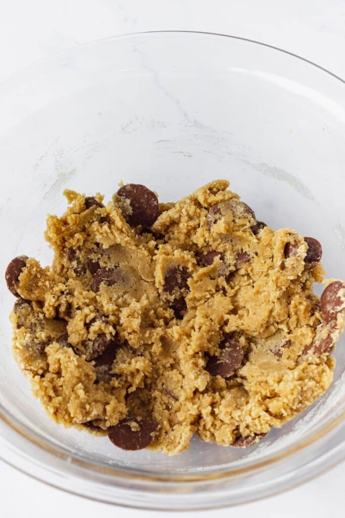 Cookie dough in a glass mixing bowl.