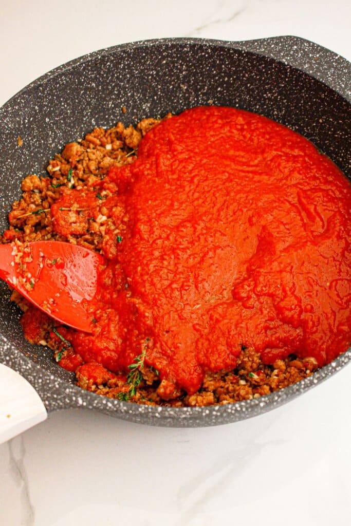 Tomato sauce and meat in a large skillet.