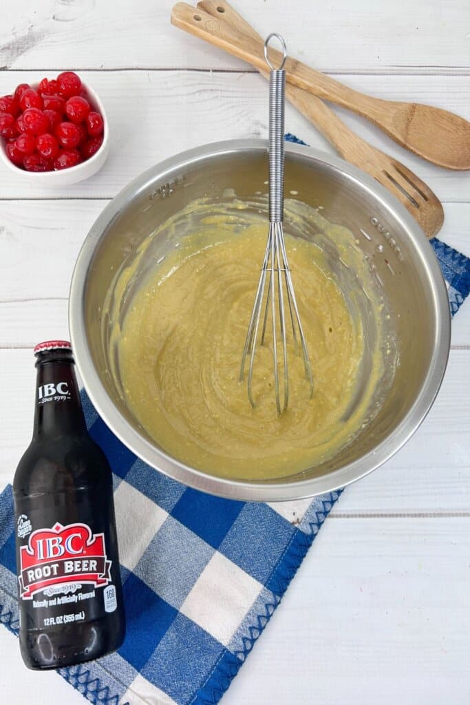 Root beer filling being mixed in a stainless steel mixing bowl.