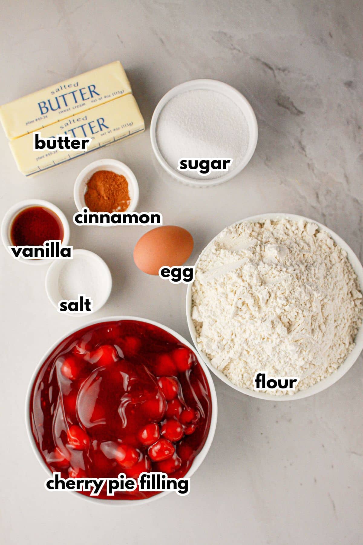 Bowls of ingredients labelled with text on a counter.