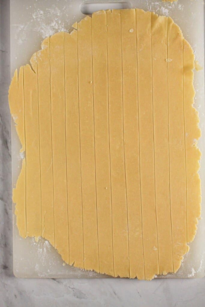 Crust being sliced into strips.