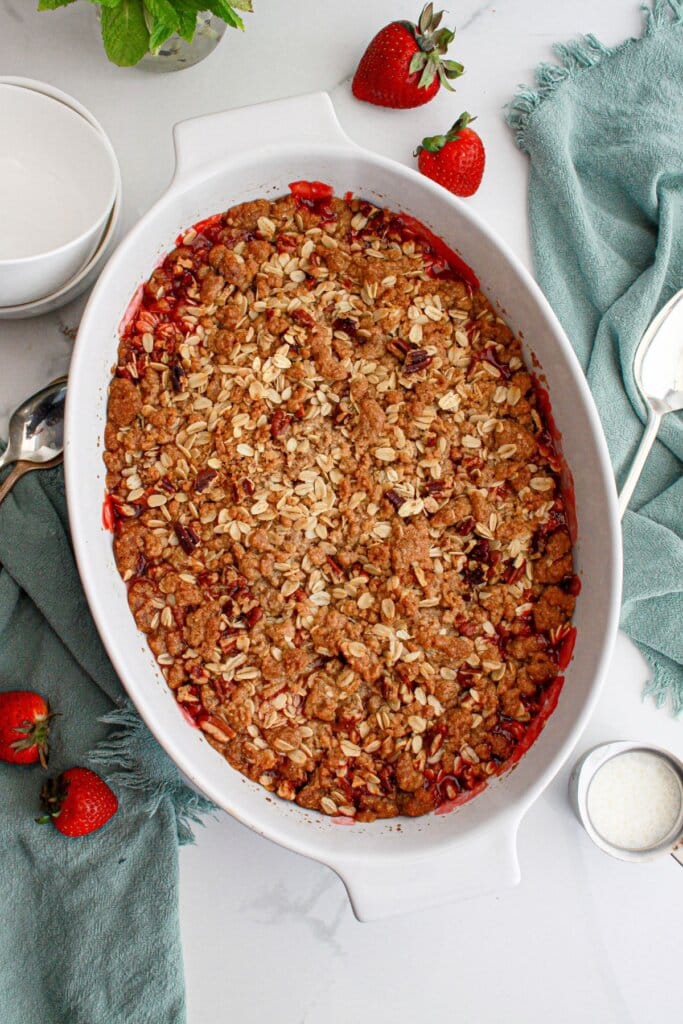 Finished rhubarb crisp in a white baking dish.