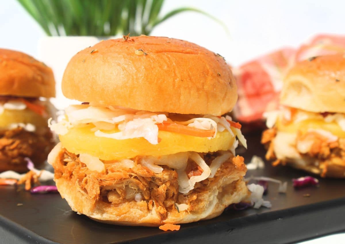Teriyaki chicken sliders on a cutting board.