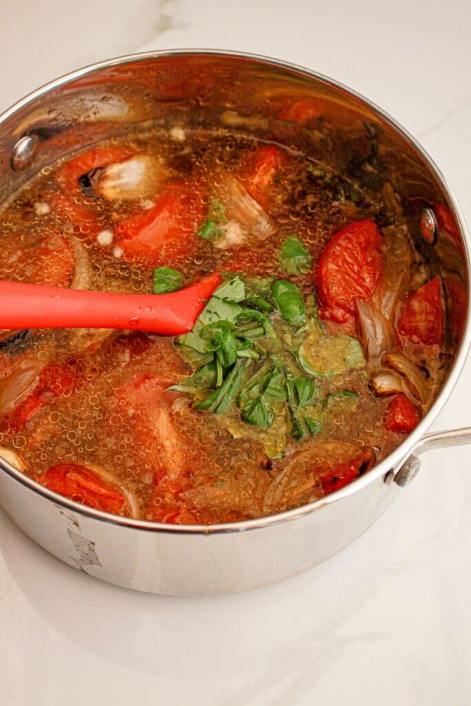 Basil being added to soup.