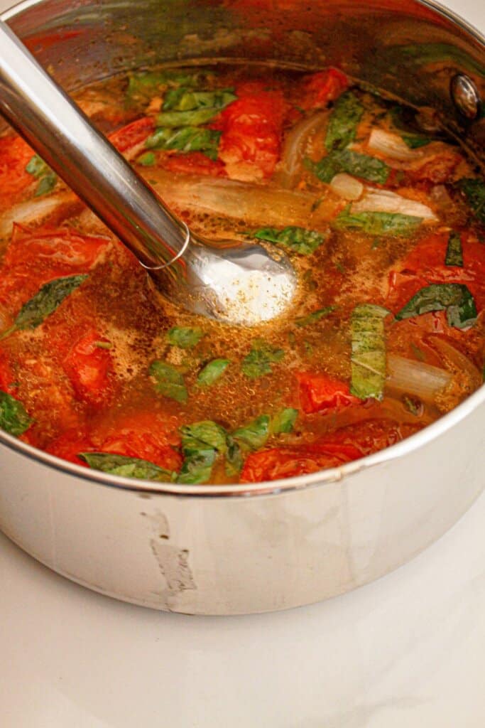 Soup being blended in a large pot.