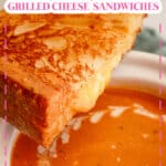 Half of a grilled cheese sandwich on top of a bowl of soup.
