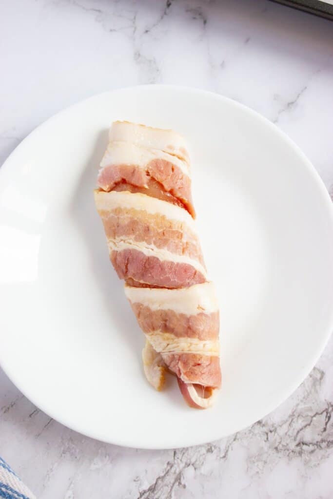 Raw meat on a white plate.