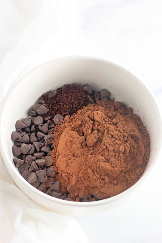 Cocoa powder, chocolate chips, and espresso in a small bowl.