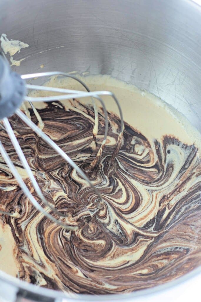 Batter being mixed in a stand mixer.