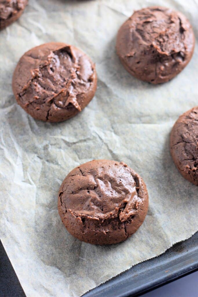 Baked cookies on a parchment lined baking sheet.