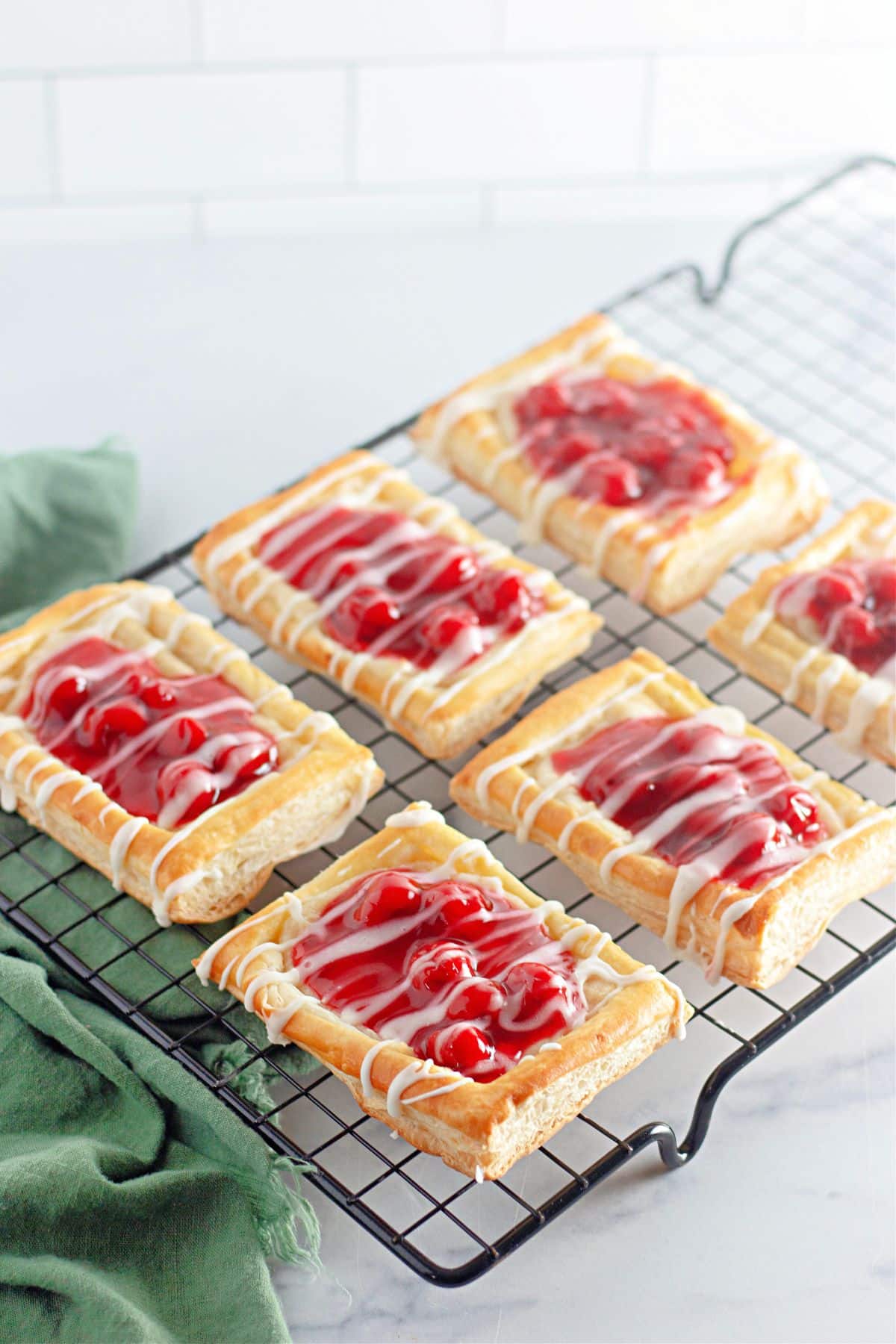 Cherry danishes on a wire cooling rack.