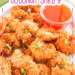Crispy coconut shrimp on a white serving platter.