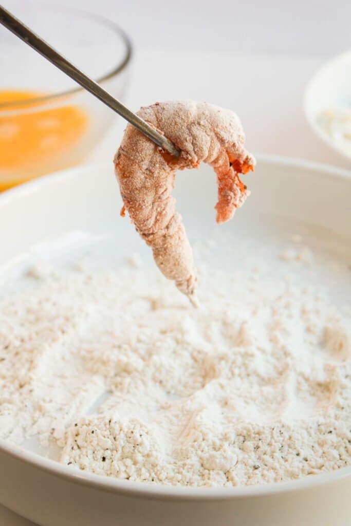 Shrimp being dredged in flour.
