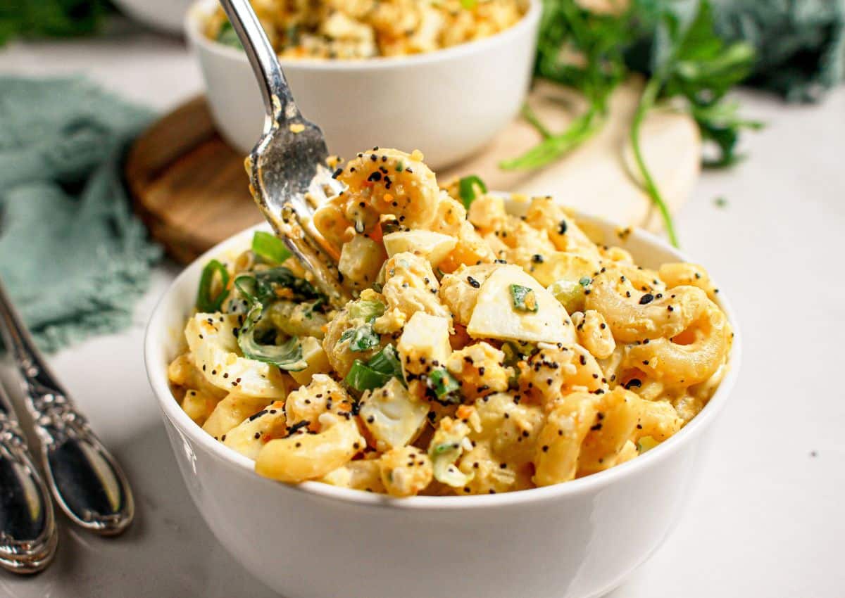 White bowl filled with everything bagel deviled egg pasta salad.
