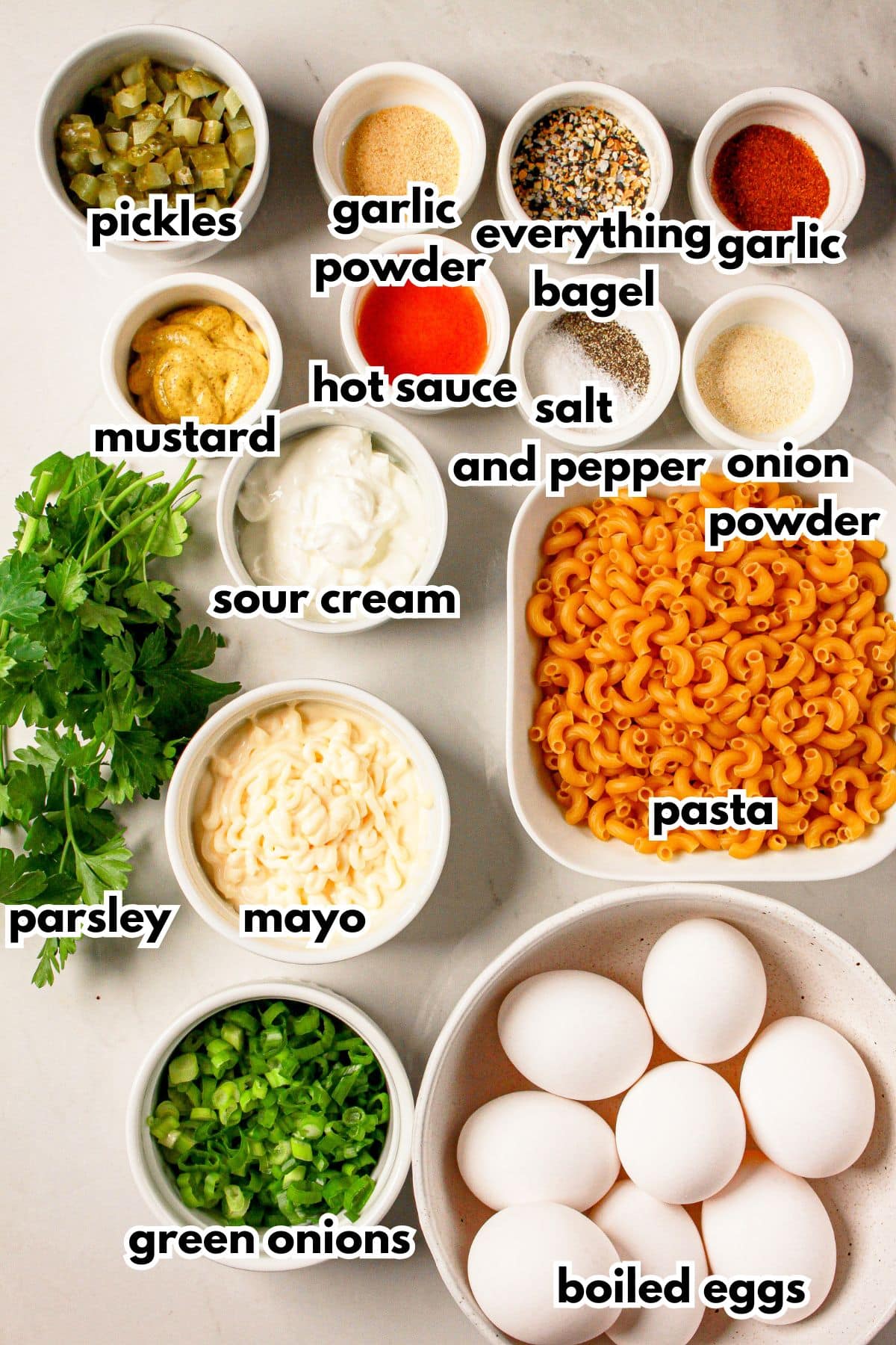 Bowls of ingredients labelled with text on a counter.